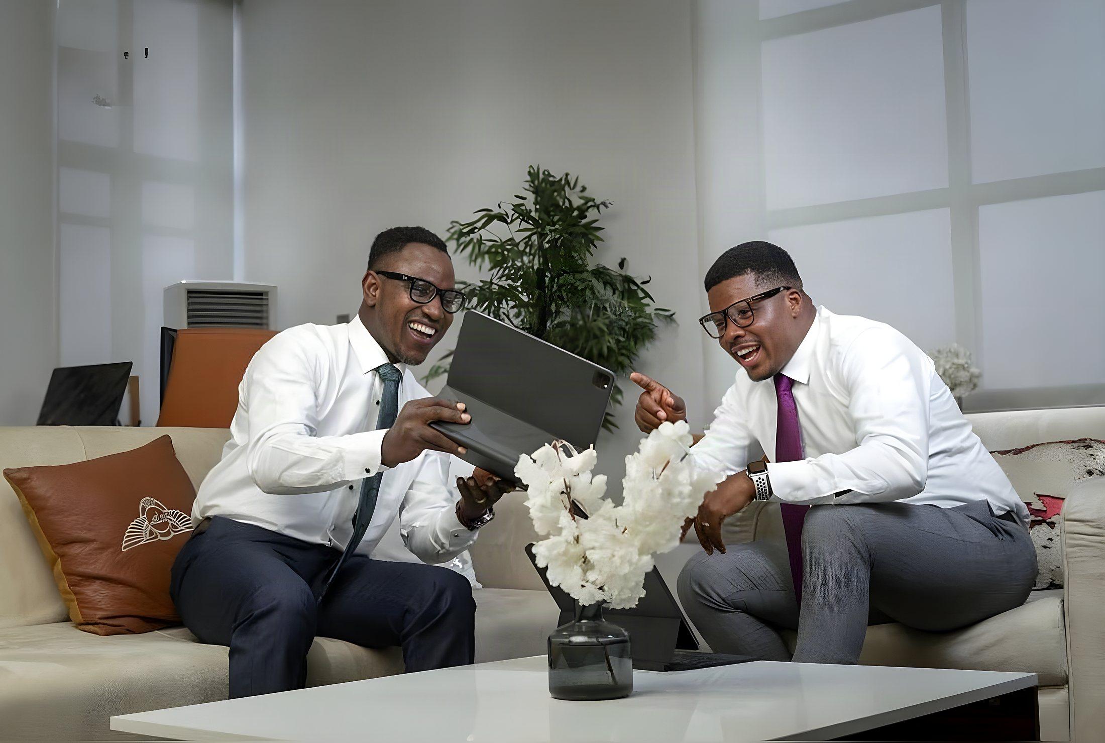 Sunday Olorunsheyi and Wisdom Ezekiel reviewing a plan together on a sofa